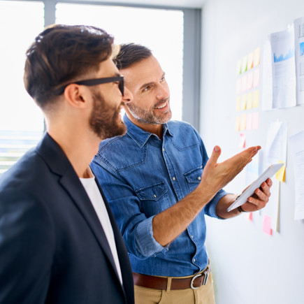 Scrum Developers with agile kanban board at TAYLLORCOX